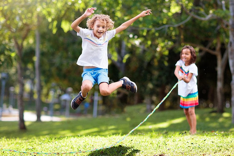 Happy kids playing outdoor games without devices